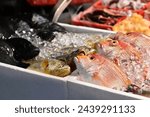 At Nanjichang Night Market in Taipei, a stir-fry stall offers affordable and diverse seafood. This close-up shot captures the fresh fish available, showcasing Taiwan