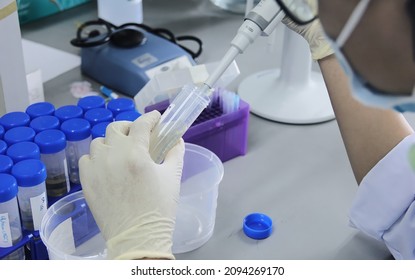 Nano Biotech Research Laboratory: unidentified male Scientist in Goggles Using Micro Pipette for Test Analysis. Advanced Scientific Lab for Nano Biotech, Biotechnology, Microbiology Development.