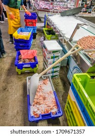 NANTES, FRANCE - MAY, 18, 2019: A Food Market Worker Is Restocking The Seafood Stand At The Market In Nantes, France.