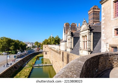 Nantes, France - September 16, 2022: View Over The Ramparts And Moat Of The Château Des Ducs De Bretagne (Castle Of The Dukes Of Brittany) Overlooking The Tramway Track.