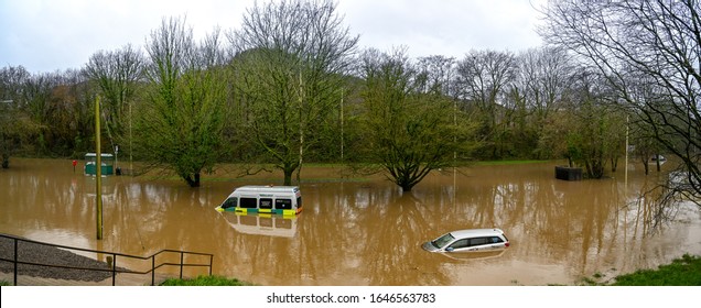 NANTGARW, NEAR CARDIFF, WALES - FEBRUARY 2020: Panoramic view of a car and an ambulance submerged in storm water after the River Taff burst its banks near Cardiff. 