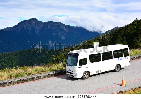 Nantou,\
Taiwan-6/10/2020: White buses travel on the highest highway in\
Taiwan. The background is Chilai North\
Peak.