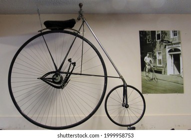 Nantucket, Massachusetts - September 5, 2015. An 1800s big wheel bicycle hangs on the wall of a bicycle shop.                               