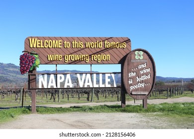 NAPA VALLEY CALIFORNIA - FEB 6,  2022: Wooden welcome sign for Napa Valley set before rows of grape vines. Napa Valley is widely considered one of the top American Viticultural Areas in USA.