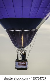 NAPERVILLE,ILLINOIS/USA - JUNE 12, 2016: The Pilot Of A RE/MAX Hot Air Balloon Aims A Tall Gas Flame Overhead To Gain Or Maintain Altitude On An Evening Flight In This Western Suburb Of Chicago.