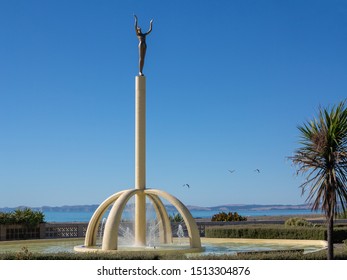 Napier, Hawkes Bay, New Zealand - Feb 7 2015: Spirit Of Napier Known As Gilray Fountain Is The Iconic Napier's Statue Symbolizes City Rising From The Ashes After The 1931 Earthquake. Space For Text.