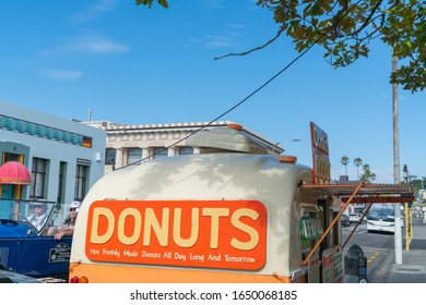 Napier - New Zealand - February 16 2020; Donuts Food Cart Opens In Napier Street With Large Orange Colored Sign.