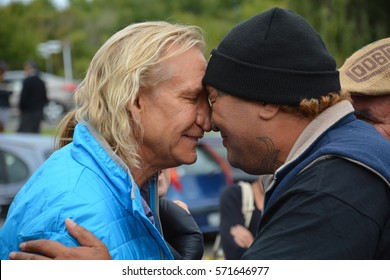 NAPIER, NEW ZEALAND - MARCH 17, 2015. Eagles Guitarist Joe Walsh Making A Traditional Maori Greeting Hongi With Native Maori In Napier.