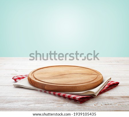 Napkin and board for pizza on wooden desk mockup perspective. Kitchen background selective focus.