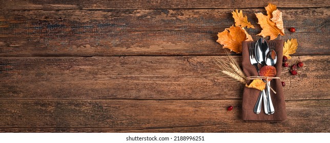 Napkin, cutlery and autumn leaves on a wooden background with space to copy. The concept of Thanksgiving, Halloween - Shutterstock ID 2188996251