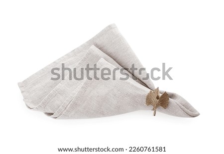 Napkin with decorative ring for table setting isolated on white