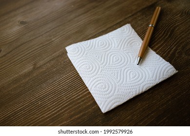 A napkin with a handle on a wooden table with a place for your inscription - Powered by Shutterstock