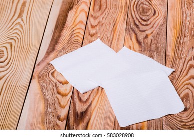 Napkin Isolated On Wooden Background. Kitchen Paper Serviette. Clean Food Towel In Restaurant. Single Square Shape Object. Blank Tablecloth On Table. Domestic, Cafe Cloth.