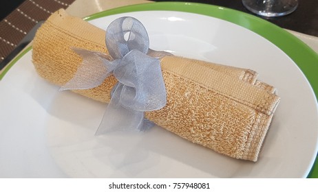 A Napkin Tied With A Lavendar Ribbon.