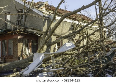 NAPLATE, IL/USA - MARCH 3, 2017: Twisted Aluminum Siding And A Fallen Tree Lie By A Severely Damaged House After An EF-3 (enhanced Fujita Scale) Tornado Devastated This Small Town On February 28.