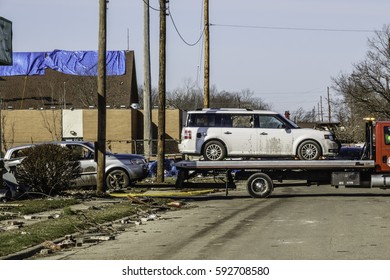 NAPLATE, IL/USA - MARCH 3, 2017: A Flatbed Truck Tows Two Cars Across An Intersection During Recovery From An EF-3 (enhanced Fujita Scale) Tornado That Blasted This Small Town On February 28.