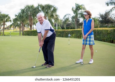 Naples, FL - December 27 2015: A Happy Retired Couple Enjoys A Game Of Golf At Their Florida Resort.