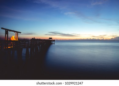 NAPLES (FL), USA - July 2017, Long Exposure At Sunset With Busy Fisherman Working On Naples Pier.