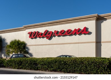 Naples, Florida, USA - December 31, 2021: Walgreens sign on the building  in Naples, Florida, USA. Walgreens Walgreen is an American company that operates a pharmacy store chain. 