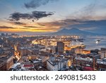 Naples, Italy city skyline overlooking the port towards Vesuvius at dawn.