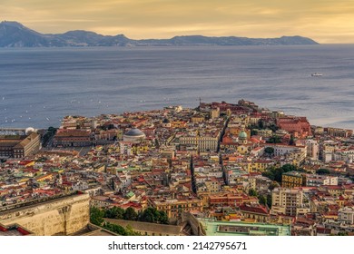Naples, Italy evening panorama of city center coastal section with Plebiscito square and Palazzo Real visible during sunset.