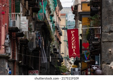 Naples, Italy. May 27, 2022. Red Pizzeria Sign Above The Street In Naples, Italy