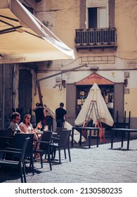 NAPLES, ITALY - Oct 01, 2019: A Vertical Shot Of People In Cafe, Naples, Italy