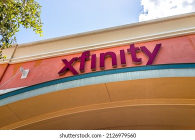 Naples, USA - August 7, 2021: Naples, Florida Comcast Xfinity Sign For Business Office In Strip Mall Closeup Of Wall And Nobody