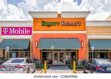 Naples, USA - August 7, 2021: Naples, Florida Equity Realty Real Estate Sign For Business Office In Strip Mall With T-Mobile Office And Parking Lot