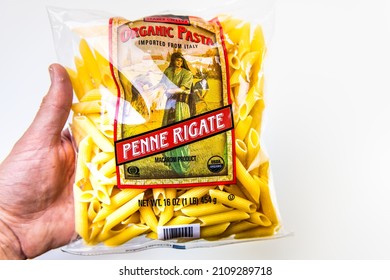 Naples, USA - October 21, 2021: Closeup Macro Hand Holding Grocery Product Of Trader Joe's Brand Private Label Sign Text For Organic Penne Rigate Pasta Product Of Italy