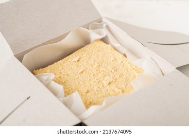 Napoleon Cake In A Cardboard Box. Sweet Gift. Delivery Of Confectionery.