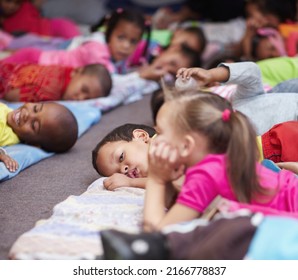 Nap-time. Preschool children all lying down and getting ready for bed. - Shutterstock ID 2166778837