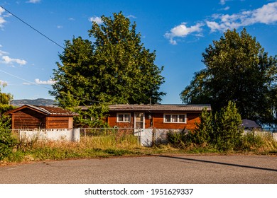 NARAMATA, CANADA - JULY 5, 2020: residential arei in small town house and white fence