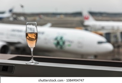 Narita Airport, Tokyo, Japan, April 2018 - At Airport Lounge With A Glass Of Champagne Overlooking The Runway.