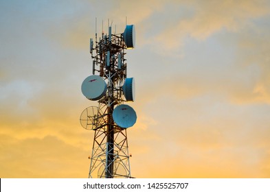 NARRABRI, AUSTRALIA : Telecommunications tower with microwave repeater dishes and bristling with antennae against a stormy sunset sky, speaks of busy electronic communications across vast distances. - Shutterstock ID 1425525707