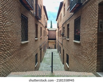 Narrow alley between two buildings in Toledo, Spain - Powered by Shutterstock