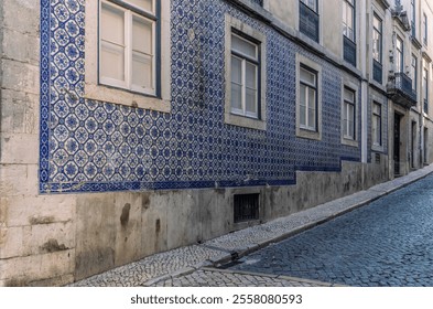 The narrow alleys and old buildings of the Alfama neighborhood in Lisbon in the late afternoon - Powered by Shutterstock