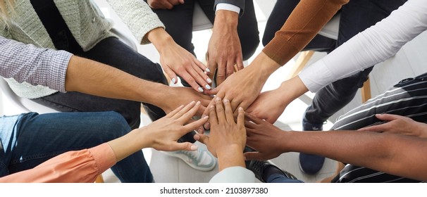 Narrow banner of multiracial people stack hands motivated for shared business success or goal achievement. Diverse intentional employees involved in teambuilding activity. Teamwork, cooperation. - Shutterstock ID 2103897380