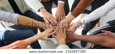 Narrow banner of multiracial people stack hands motivated for shared business success or goal achievement. Diverse intentional employees involved in teambuilding activity. Teamwork, cooperation.