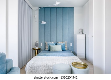 Narrow Blue And Gray Bedroom With Double Bed And Upholstered Wall