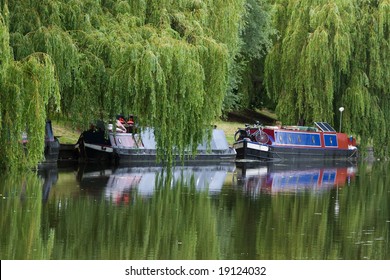 Narrow boat barge under the green trees (Cambridge, UK)