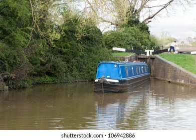 Narrow boat navigating a lock on a canal