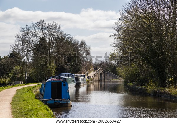 Narrow boats moored along the main stretch of\
the Leeds Liverpool Canal near Burscough, Lancashire next to the\
Rufford junction.