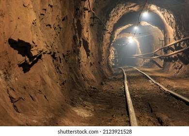 Narrow gauge railroad in the underground mine horizon. Technologies of mining of minerals by underground method. Underground mine for mining ore