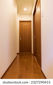 A narrow hallway with a sliding door in the back