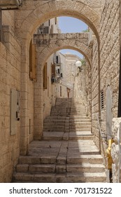 Narrow jerusalem street with stairs and stone walls