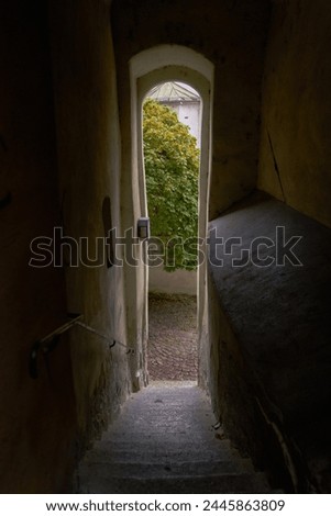 Narrow Old Passageway in Europe. A doorway onto an alley at the end of a narrow passageway in a historic medieval European town.

                             