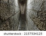 Narrow passage between castle walls made of stone blocks