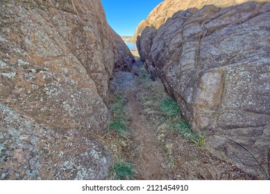 A narrow path between walls of Granite that marks the beginning of the Red Bridge Trail at Willow Lake in Prescott Arizona. - Powered by Shutterstock