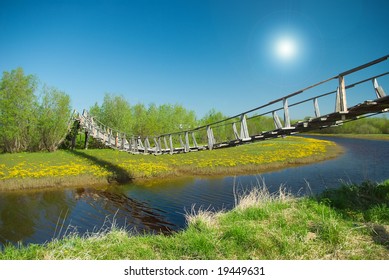 Narrow Rope Pedestrian Bridge Over Water